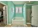 Bright bathroom featuring a white soaking tub and a glass enclosed walk-in shower, next to the walk-in closet at 1651 Fairforest Ct., Conway, SC 29526