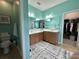 Bright bathroom with dual sinks, a large mirror, and a doorway leading to a walk-in closet at 1651 Fairforest Ct., Conway, SC 29526