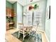 Inviting dining area with granite counters and white chairs around a floral table setting at 1651 Fairforest Ct., Conway, SC 29526