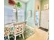 Bright dining area with a floral table setting, a modern chandelier, and a nearby laundry room at 1651 Fairforest Ct., Conway, SC 29526