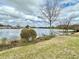 Picturesque lake view showcasing the water, shoreline, and surrounding homes under a cloudy sky at 1651 Fairforest Ct., Conway, SC 29526