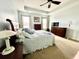 Spacious bedroom with a tray ceiling, ceiling fan, and natural light from two windows at 1651 Fairforest Ct., Conway, SC 29526