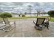 An outdoor patio with comfortable seating, perfect for enjoying the tranquil views of the adjacent lake at 1651 Fairforest Ct., Conway, SC 29526