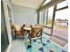 Enclosed sunroom featuring a table and four chairs, along with a bright, modern rug and a beautiful lakeside view at 1651 Fairforest Ct., Conway, SC 29526