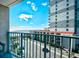 Balcony view showcasing beachfront condo and parking lot under a bright, cloudy sky at 201 74Th Ave. N # 2549/2550, Myrtle Beach, SC 29577