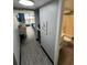 Hallway view leading to bedroom and bathroom, with convenient amenities like a microwave at 201 74Th Ave. N # 2549/2550, Myrtle Beach, SC 29577