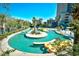 Lushly landscaped lazy river and resort pool with palm trees and lounge chairs at 201 74Th Ave. N # 2549/2550, Myrtle Beach, SC 29577