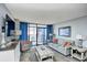 Bright living room with comfortable seating and a sliding glass door to the outside balcony at 201 74Th Ave. N # 2549/2550, Myrtle Beach, SC 29577