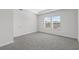 Bright bedroom featuring carpet flooring and a large window at 2020 Copper Creek Loop, Longs, SC 29568