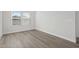 Bright bedroom featuring luxury vinyl plank flooring and a large window at 2020 Copper Creek Loop, Longs, SC 29568