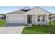 Charming one-story home with white brick, a two-car garage, a well-manicured lawn and a welcoming front porch at 2020 Copper Creek Loop, Longs, SC 29568