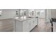 Bright kitchen island with white cabinetry and a stainless steel dishwasher at 2020 Copper Creek Loop, Longs, SC 29568