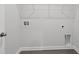 A bright, empty laundry room with hookups and hardwood style flooring at 2020 Copper Creek Loop, Longs, SC 29568