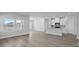 An open-concept space featuring a living area that leads to the kitchen with modern white cabinets at 2020 Copper Creek Loop, Longs, SC 29568