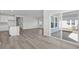Open floor plan with luxury vinyl plank, a kitchen island, and access to a covered patio at 2020 Copper Creek Loop, Longs, SC 29568