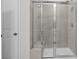 Glass-enclosed shower with a built-in bench and tiled walls at 2020 Copper Creek Loop, Longs, SC 29568