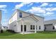 Exterior of a home with a covered patio, green lawn, and white vinyl siding at 2044 Copper Creek Ct., Longs, SC 29568