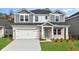 Two-story home featuring a brick and gray shingle exterior, attached garage and well-manicured lawn at 2044 Copper Creek Ct., Longs, SC 29568