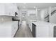 Modern kitchen with white cabinets, stainless steel appliances, and a spacious center island at 2044 Copper Creek Ct., Longs, SC 29568