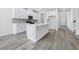 Stylish kitchen with white cabinetry, an island, and stainless steel appliances at 2044 Copper Creek Ct., Longs, SC 29568