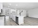 Modern kitchen with white cabinetry, an island, and stainless steel appliances, open to the living area at 2044 Copper Creek Ct., Longs, SC 29568