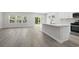 Open-concept living room with wood-look floors, seamlessly connected to the modern kitchen at 2044 Copper Creek Ct., Longs, SC 29568