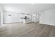 Open-concept living room with wood-look floors, seamlessly connected to the modern kitchen at 2044 Copper Creek Ct., Longs, SC 29568