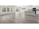 Spacious living room with wood-look floors, featuring a seamless flow to the kitchen at 2044 Copper Creek Ct., Longs, SC 29568