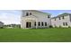 A spacious backyard with well-maintained lawn and a covered patio area, perfect for outdoor gatherings at 2052 Copper Creek Ct., Longs, SC 29568