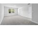 Well-lit bedroom with neutral walls, carpet, and a large window overlooking the outdoors at 2052 Copper Creek Ct., Longs, SC 29568