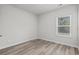 Bedroom featuring neutral walls and wood-look flooring, with a window that lets in natural light at 2052 Copper Creek Ct., Longs, SC 29568