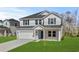 Charming two-story home featuring a two-car garage, well-maintained lawn, and inviting front porch at 2052 Copper Creek Ct., Longs, SC 29568