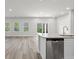 Modern kitchen featuring white cabinets, stainless steel appliances, and a seamless transition to the living area at 2052 Copper Creek Ct., Longs, SC 29568