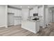 Bright kitchen featuring white cabinets, stainless steel appliances, and a center island at 2052 Copper Creek Ct., Longs, SC 29568