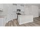 Modern kitchen with white cabinets, stainless steel appliances, and granite countertops at 2052 Copper Creek Ct., Longs, SC 29568