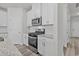 Modern kitchen with stainless steel appliances and white cabinets and countertops at 2052 Copper Creek Ct., Longs, SC 29568
