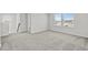 Loft area featuring neutral paint and carpet with stairs and views to the exterior through windows at 2052 Copper Creek Ct., Longs, SC 29568