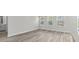 Bright room with wood-look floors and natural light featuring 3 large windows with a view outside at 2052 Copper Creek Ct., Longs, SC 29568