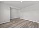 Large room with neutral walls and wood-look floors with an open doorway leading to another room at 2052 Copper Creek Ct., Longs, SC 29568