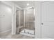 Bathroom shower features a glass door, seat, tiled walls and floors at 2052 Copper Creek Ct., Longs, SC 29568