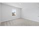 Cozy bedroom featuring a bright window, neutral walls, and soft carpeting at 2104 Copper Creek Ct., Longs, SC 29568