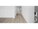 Bright hallway with stylish light wood flooring leading to a sunlit area at 2104 Copper Creek Ct., Longs, SC 29568