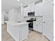 Modern kitchen with white cabinets, stainless steel appliances, and a spacious island at 2104 Copper Creek Ct., Longs, SC 29568