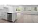 Open concept kitchen with an island, modern appliances, and a view to the patio at 2104 Copper Creek Ct., Longs, SC 29568