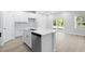 Kitchen with island and stainless steel appliances offering an open view to living space and outdoors at 2104 Copper Creek Ct., Longs, SC 29568