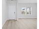 Well lit Living room featuring light wood flooring, fresh white walls, and large windows at 2104 Copper Creek Ct., Longs, SC 29568