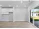 Open-plan living space connecting kitchen to living room with sliding door access to outdoor patio at 2104 Copper Creek Ct., Longs, SC 29568