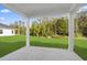 Covered patio showcasing picturesque view of landscaped backyard and green space at 2104 Copper Creek Ct., Longs, SC 29568