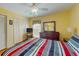 Bright bedroom features a striped bedspread, ample closet space, and a decorative dresser at 212 58Th Ave. N # 1C, North Myrtle Beach, SC 29582
