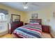 Well-lit bedroom features a striped bedspread, hard wood floors and decorative furnishings at 212 58Th Ave. N # 1C, North Myrtle Beach, SC 29582